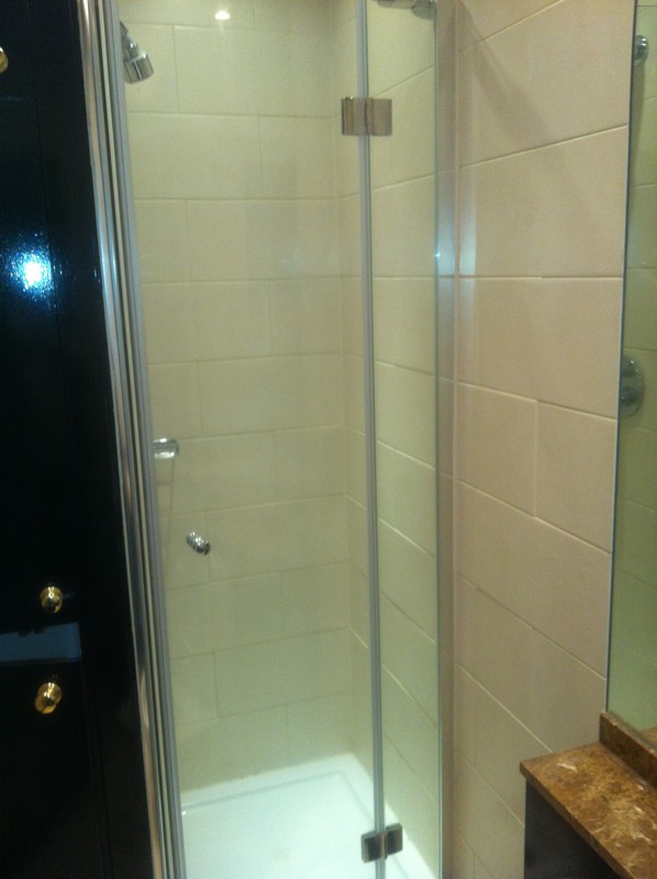 Frameless glass shower enclosure with chrome fittings in Lambeth