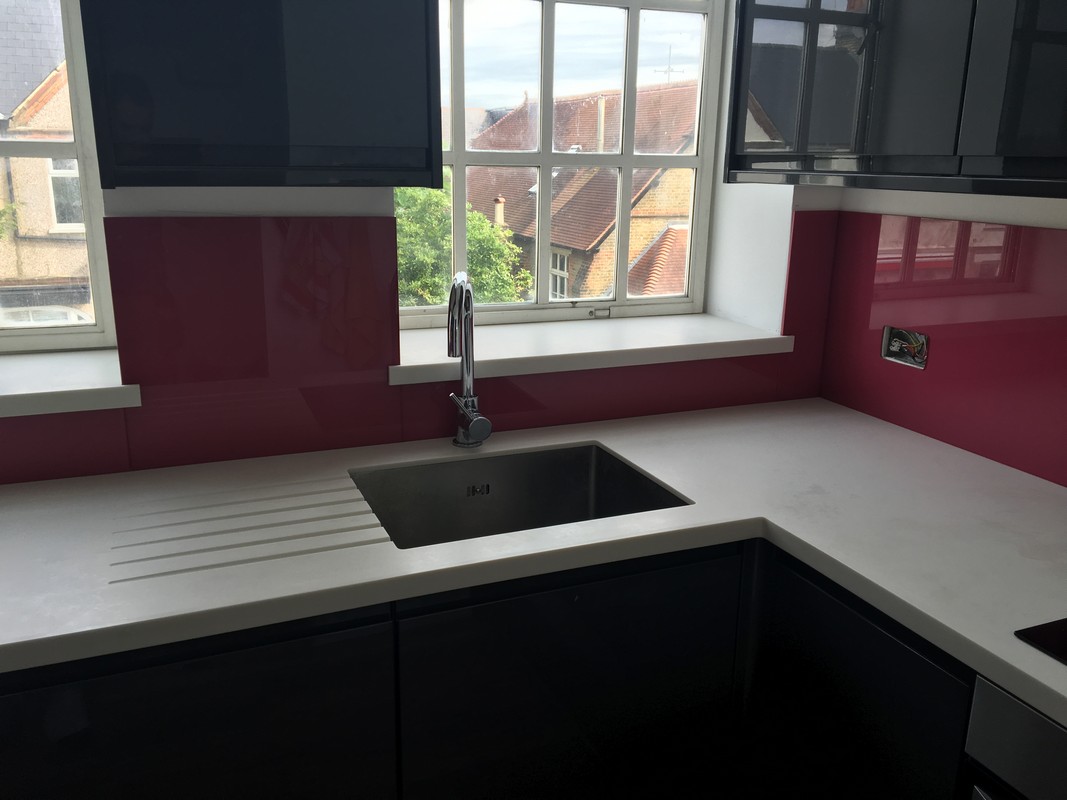 Deep plum coloured glass splashback in modern Lambeth kitchen