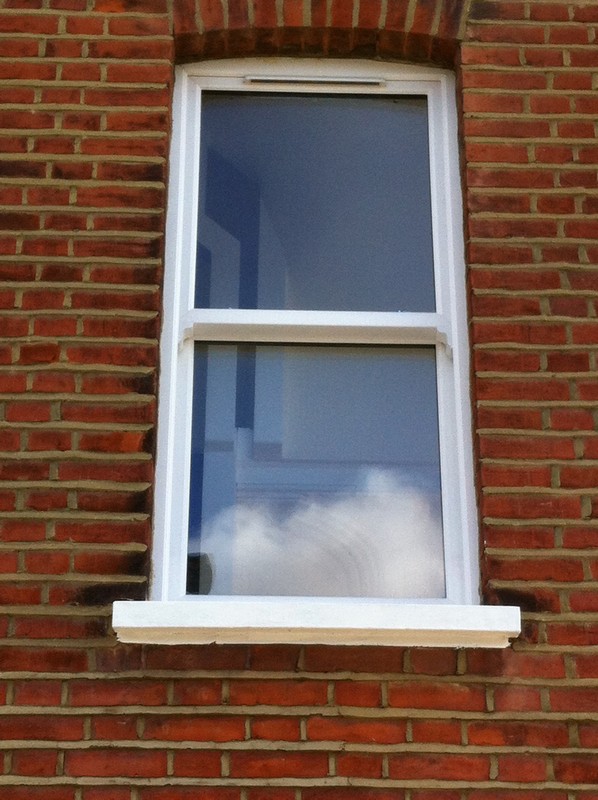 uPVC sash window on Victorian red brick house in Lambeth